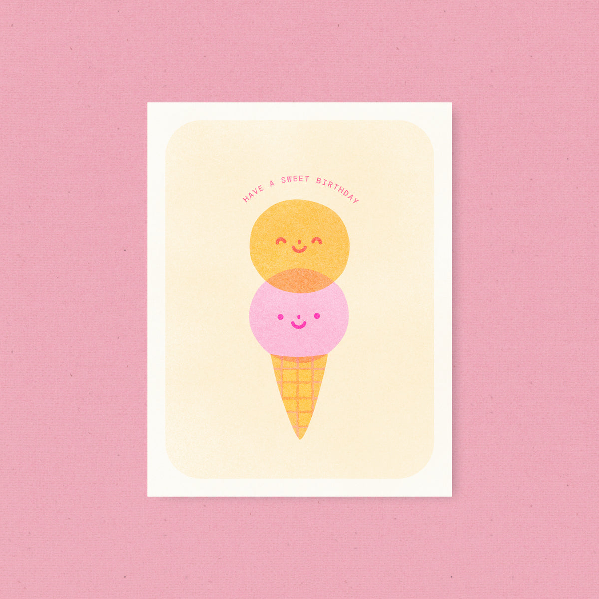 Whimsical risograph birthday card printed with fluorescent pink and yellow vegetable-based inks, featuring a cute smiling double-scoop ice cream cone. The words "Have a Sweet Birthday" arch above it, and a kraft envelope is included. A delightful handmade card from Seattle, WA by Minna May.
